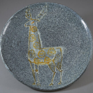 An Alfaraz reindeer charger inspired by neo-lithic art with blue stippled glaze.