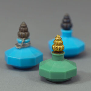 A trio of Richard Hudnut Le Debut miniature perfume bottles in green and blue.