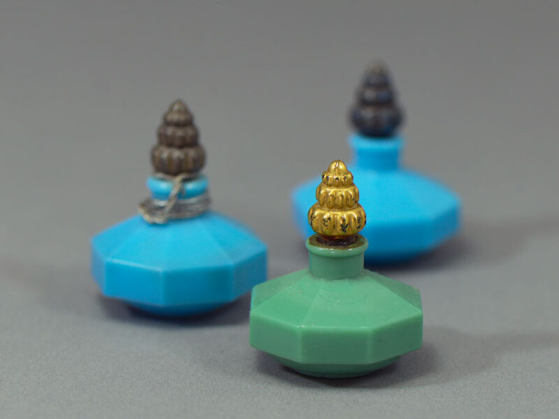 A trio of Richard Hudnut Le Debut miniature perfume bottles in green and blue.