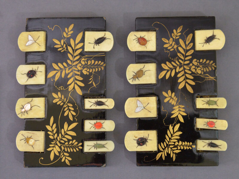 Japanese lacquere whist markers with ivory tabs each enamelled with an insect, the bodies decorated with elaborate gilt flora.