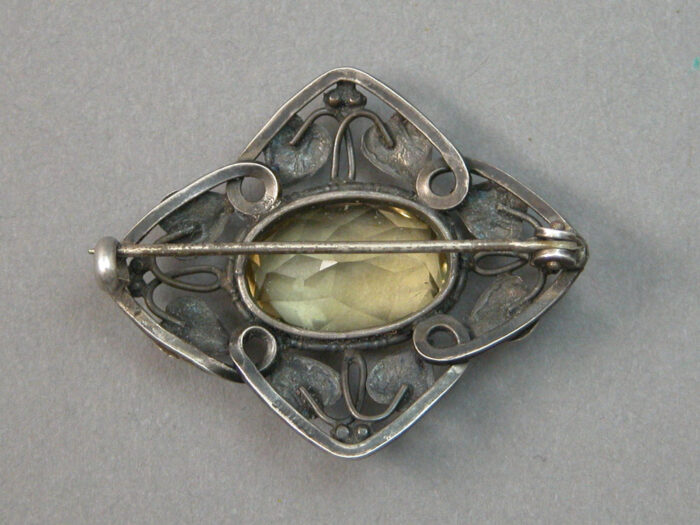 The backside of an American Arts & Crafts Brooch of Sterling Silver with a central citrine