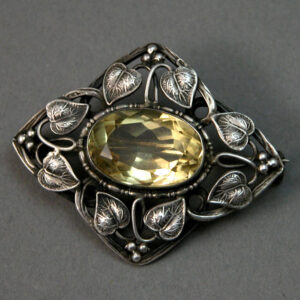 Sterling Silver Arts & Crafts Brooch with Entqined Vines surrounding a central citrine gem