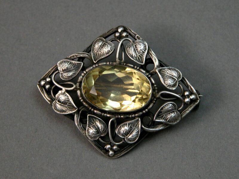 Sterling Silver Arts & Crafts Brooch with Entqined Vines surrounding a central citrine gem