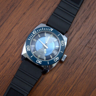 1970s watch with stainless steel case, blue dial and black band