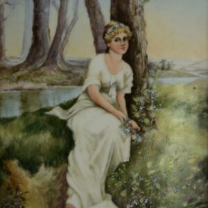 A blonde in a white dress sits in the grass and rests against a tree, she is surrounded by lush foliage and flowers which she holds in her hands and which form a diadem in her hair; her gaze is directed towards the viewer. A river runs through the background, separating her from the forested far shore and a light glow, like the flush of her skin, has begun to illuminate the clear blue skies from beyond the mountainous peaks.