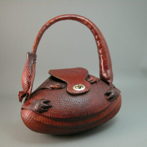 Vintage purse made from the body of an armadillo with head eating tail handle