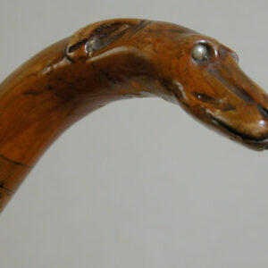 Wooden cane with carved dog head handle, inset bead eyes.