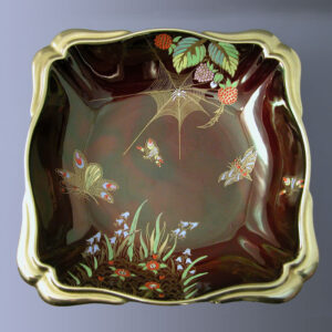 A square dish with scalloped corners and gilt edge in the rouge royale colourway with spider webb decoration