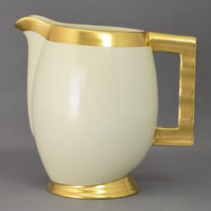 modern pitcher with gilt mouth, ripple hand and foot with egg white body.