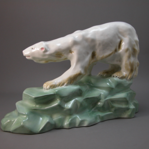 Large polar bear is modelled atop a mint green rocky integral plinth.