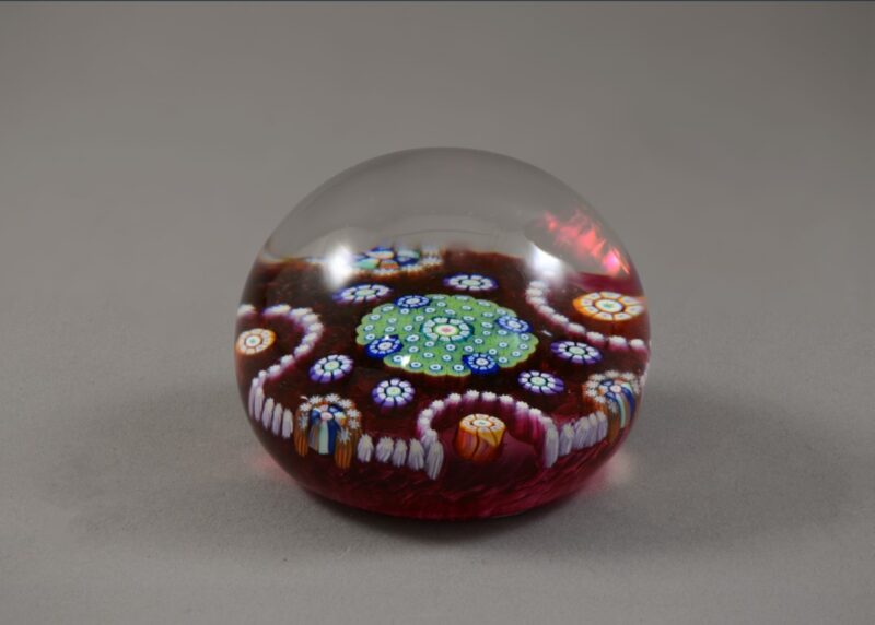 Complex cane paperweight with red ground, number PP49.