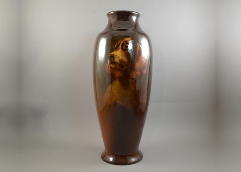 Large 19" tall baluster vase with hand painted portrait of the hunter arms trademark springer spaniel and burnished on the reverse in gothic script First Price Class A Trophy, on a rosewood ground, c. 1900.